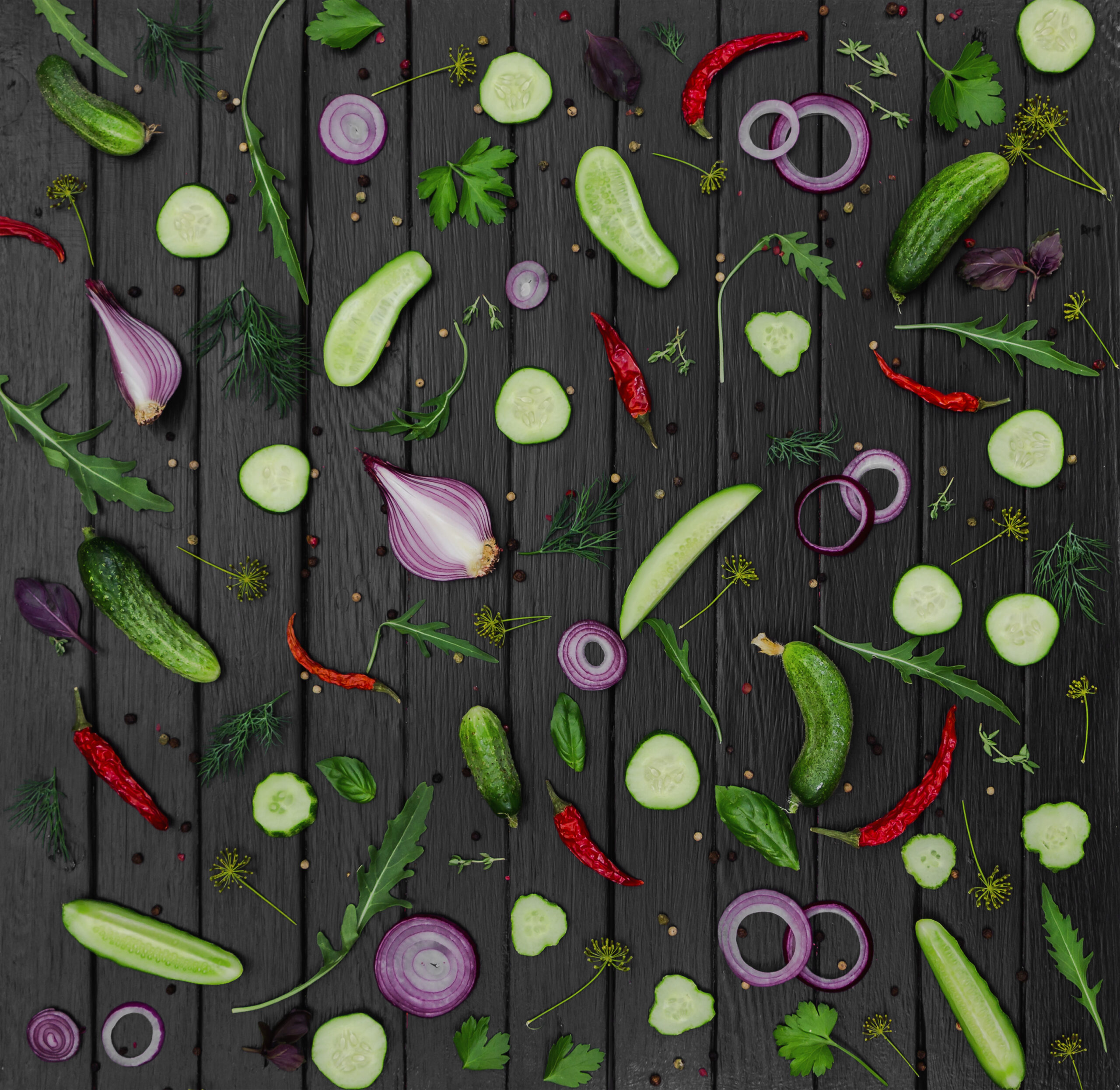 Flat lay composition with cucumber, onion, aromatic herbs and ar