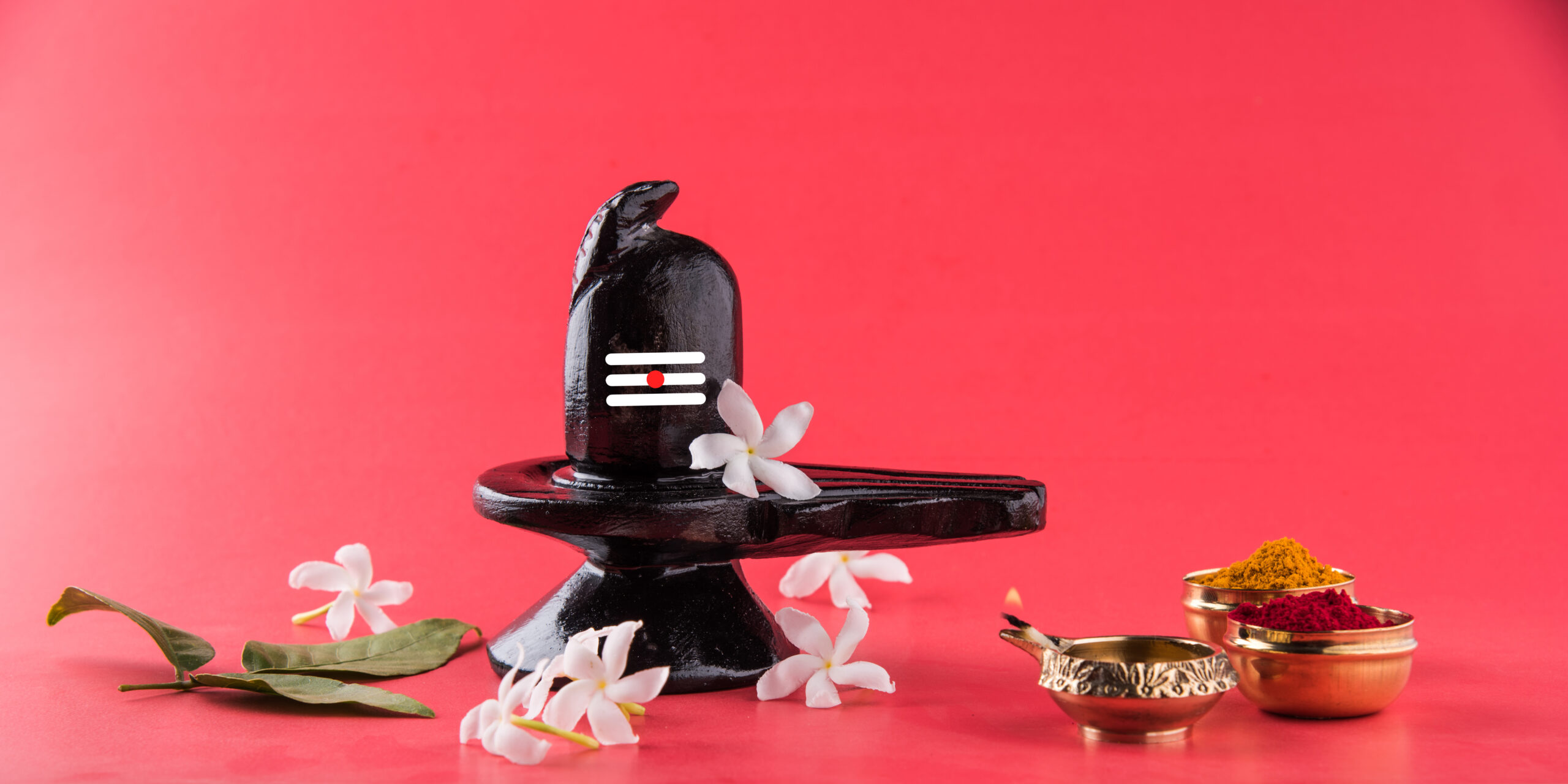 Shiva Linga decorated with flowers & bel patra or leaf and haldi kumkum for Pooja or worshipping of Lord shiva or Shankar bhagwan